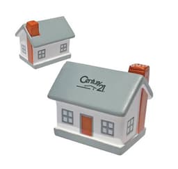 A house-shaped stress reliever in grey, white, and orange, featuring a chimney and a logo on the front.
