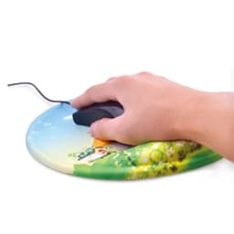 A round gel mouse mat featuring a colourful landscape design with a house and greenery, with a hand using a mouse on it.