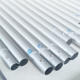 Several silver metallic poles arranged in parallel, featuring small pins and connectors at their ends.