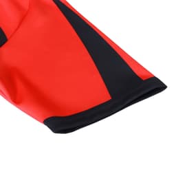 A red and black crew neck raglan sport tee shirt with a micro mesh design and a logo.