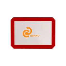 A silicone baking mat with a red border and a logo in the centre. The mat is predominantly grey.