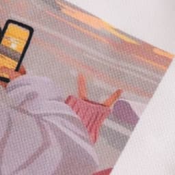 A close-up of a textured fabric featuring a full-colour design, part of a velvet tote bag.