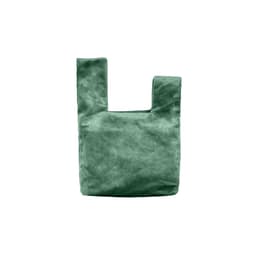 A green velvet wrist bag with a unique knot design and a simple, minimalistic shape. It features a logo.