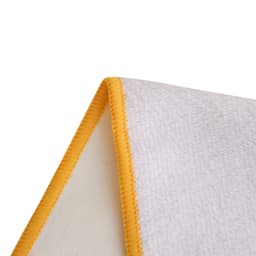 A white sports towel featuring a vibrant yellow trim, designed for leisure and gym use. Includes a logo.