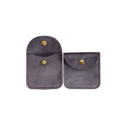 A grey velvet jewelry pouch with a snap closure and a small front pocket. It features a branding logo.