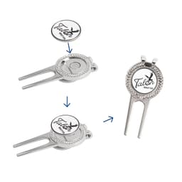 A silver golfers divot tool with a detachable ball marker, featuring a logo and intricate detailing.