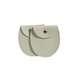 A set of two oval-shaped, light grey PU leather jewelry pouches with a gold-tone snap closure.