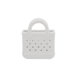 A white mini EVA bag charm with a textured finish and perforated design. It features small handles on top.