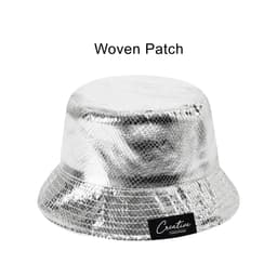 A silver bucket hat with a shiny, glittery finish and a woven patch on the side.