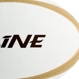 A white rugby ball with a textured surface and a brand logo featuring black and gold accents.