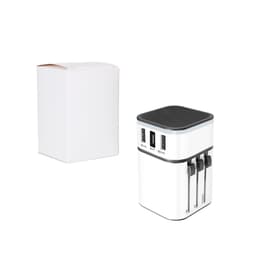 A white travel adapter with black accents, featuring multiple USB ports, beside a plain white box.