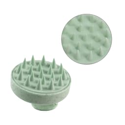 A green hair scalp massager with textured spikes for stimulating the scalp, featuring a circular design.