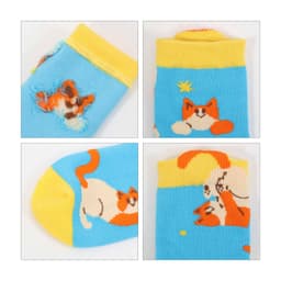 Bright blue socks featuring playful cat designs in orange and yellow, with a yellow cuff and a logo.