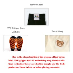 Custom patterned woven socks in black featuring a woven label, PVC gripper dots on the sole, and embroidered design.