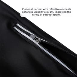 A close-up of black cycling tights featuring a zipper with reflective elements for enhanced visibility.