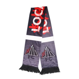 A dark grey velvet scarf with red graphic elements and two black logos, featuring fringed ends.