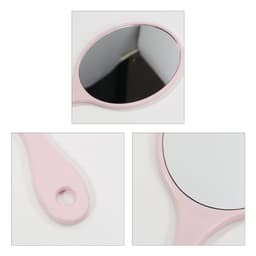 A pink handheld makeup mirror with an oval reflective surface and a looped handle. The design is chic and compact.