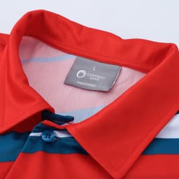 A red polo shirt with blue and white stripes, featuring buttons and a tag indicating size. It has a logo on the tag.