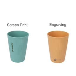 Two wheat straw toothbrush cups. One is teal with vertical ribbing, and the other is tan, also ribbed, featuring branding.