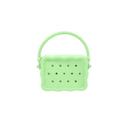 A green silicone bag with holes and a textured handle, featuring a scalloped design.