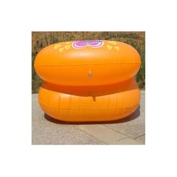 Two orange custom inflatable chairs stacked on a paved surface, featuring a logo on the front.