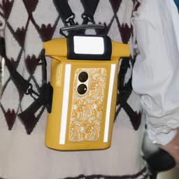 A waterproof yellow crossbody handlebar bag with reflective strips and a decorative design, featuring a logo.