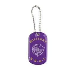 A purple dog tag with a decorative design and a silver chain. It features a logo and the text "MILITARY BRAT".