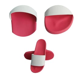 PVC slides featuring a pink sole and a white strap, displayed from multiple angles. Includes one logo.