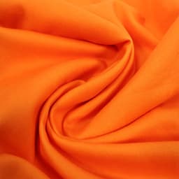 A close-up view of bright orange brushed Lycra fabric, showing its smooth texture and folds.