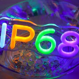 A vibrant neon LED sign featuring the colours orange, green, and purple, submerged in water with ice.