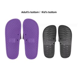 A pair of PVC slides featuring a purple adult size sole and a black kid size sole, each with textured bottoms.