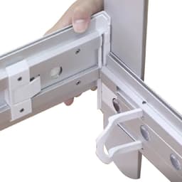 A close-up of a hand adjusting the connector of a metal frame, featuring a silver finish and white plastic components.