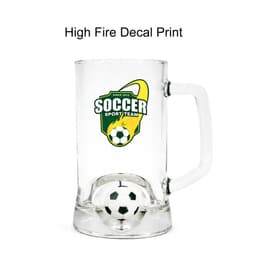 A clear glass beer mug featuring a soccer-themed design and a custom spinner toy inside.