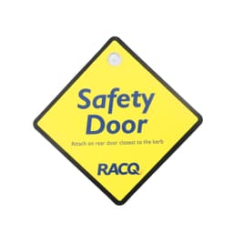 A diamond-shaped yellow warning sign with a black border and a logo, labelled "Safety Door".
