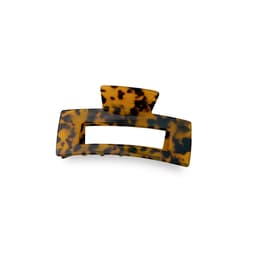 A tortoiseshell hair claw clip with a rectangular opening and a curved design, featuring a logo on the side.