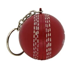 A red cricket ball stress reliever keyring with white stitching and a metal chain for attachment.