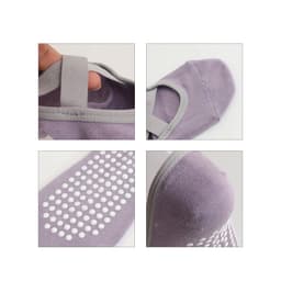 A pair of lavender yoga socks featuring a textured sole and elastic straps for a secure fit. The socks have a logo.