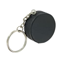 A black hockey puck stress reliever attached to a keyring with a silver chain.
