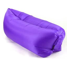 A purple portable inflatable air lounger sofa is displayed, featuring a smooth, inflated design and a small logo.