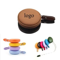 A brown PU mini tape measure with a leather-like handle and multiple colourful tape measure options in the background.