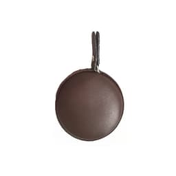 A round brown PU mini tape measure, featuring a keyring attachment. The surface has a smooth finish.