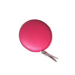 A pink PU mini tape measure with a circular design and a keyring attachment.