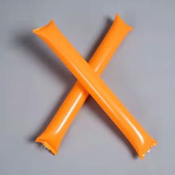 Two orange inflatable thundersticks crossed on a grey background, featuring a shiny surface and rounded ends.