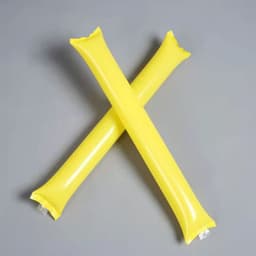 Two yellow inflatable thundersticks crossed against a grey background, featuring a smooth, glossy surface.