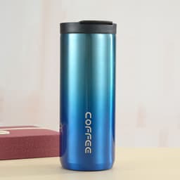 A drink bottle featuring a gradient blue design, with a vacuum insulated body and a black lid. It has a logo.