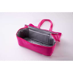 A pink oversized insulated cooler tote beach bag with a grey interior and a mesh pocket inside.