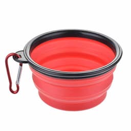 A red collapsible pet bowl made of silicone with a black rim and a metal carabiner attached.