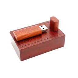 A bamboo USB stick is displayed on a wooden base, featuring a dark brown finish. The design is sleek and minimalist.