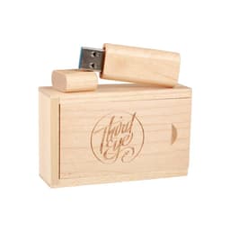 A bamboo USB stick rests in a wooden box, showcasing its natural finish and smooth design, with a logo present.