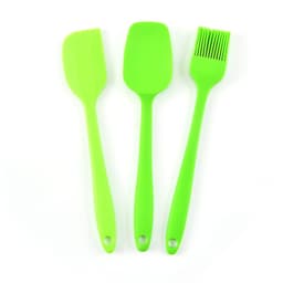 A silicone baking set featuring three green utensils: a spatula, a scoop, and a basting brush.